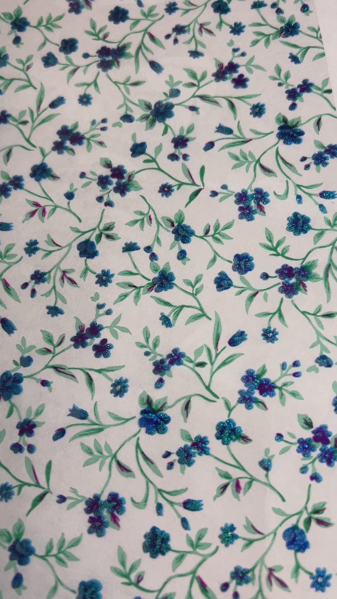 A video of a roll of blue floral transparent transfer foil